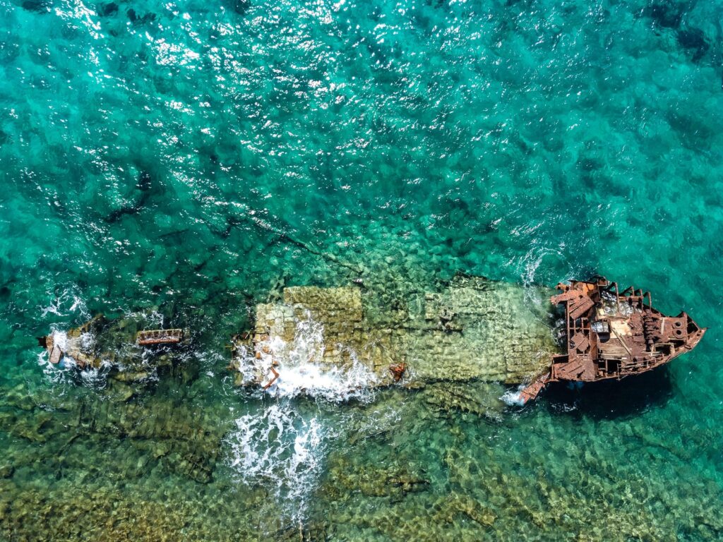 aerial photography of abandoned boat in body of water during daytime